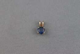 A sapphire single stone pendant, the round mixed cut bright blue stone approx .