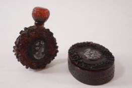 A simulated tortoiseshell oval snuff box, signed and a similar scent bottle and cover,