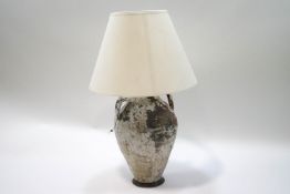 A decorative terracotta two handled jar, converted to a table lamp with shade,