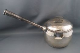 A silver saucepan and cover, with straight tapering handle, 15cm high, London 1908,