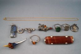 A selection of eleven items of jewellery to include a single earring of blue titanium,