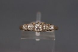 A late Victorian 18ct gold and diamond five stone carved half-hoop ring,