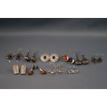 A selection of ten pairs of silver earrings consisting of plain and gemset with a variety of drops