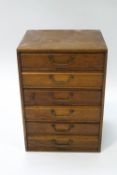 An oak six drawer collector's chest of six drawers,