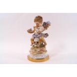 A 19th century Meissen porcelain figure of a cherub sitting upon a skull with sheafs of corn within