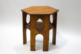 A Scottish pine occasional table with hexagonal top, the sides with pierced teardrop panels,