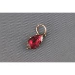 An early 19th century gold and flat-cut garnet drop shaped pendant,