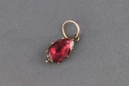 An early 19th century gold and flat-cut garnet drop shaped pendant,