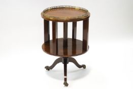 An Edwardian mahogany revolving bookcase on outswept legs and paw casters,