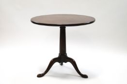 A George III style mahogany tilt top tripod table on pad feet,