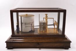 A Short & Mason of London barograph, the oak case with drawer containing spare graphs,