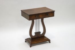 A Rehency style mahogany occasional table with lyre support on a rectangular plinth base with