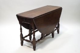 An 19th century oak oval gate leg table,