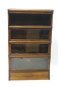 A Globe Wernicke oak four tier bookcase, the top stack open, above three glazed stacks,