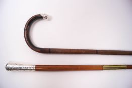 A slim walking cane with 3" silver knop, London 1920 and a walking stick with silver tip,