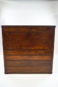 An early 19th century mahogany Continental bureau, containing eleven drawers,