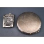 A ladies silver powder compact, of round form with engine turned decoration,