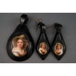 A jet pendant and a pair of earrings depicting a female portrait to each. Gross weight: 26.