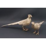 A pair of modern silver pheasants, the cock and hen modelled in a standing pose,