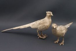 A pair of modern silver pheasants, the cock and hen modelled in a standing pose,