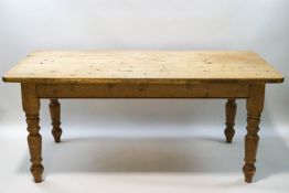 A country pine kitchen table on turned legs,