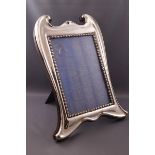 A large silver art nouveau style photograph frame, 31cm x 23cm,