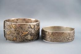 A selection of two silver bangles. One hollow silver and gilt engraved design 32.