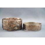 A selection of two silver bangles. One hollow silver and gilt engraved design 32.