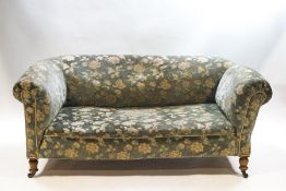 A Victorian drop end two seater sofa in the Howard & Sons style,