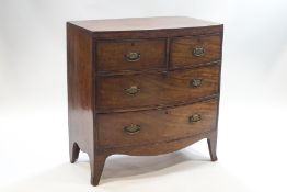 A George III mahogany bow front chest of four drawers on splay feet,