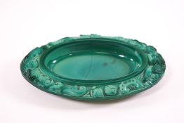 A Czech malachite glass oval dish, the border with a figure playing a pipe, an exotic bird,