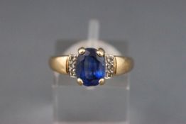 A 9ct gold, sapphire and diamond dress ring, centred with an oval native-cut sapphire approx. 2.