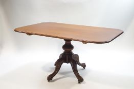 A Victorian mahogany rectangular breakfast table on a turned column and scroll legs,