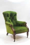 A Victorian mahogany button back armchair on turned front legs,