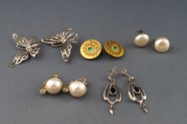 A selection of five pairs of earrings to include three pairs of silver gilt clip on,