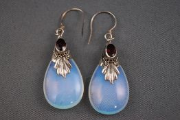 A pair of silver earrings set with a garnet and opaline stone. Hook fittings. Stamped 925. 6.