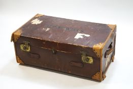 An early 20th century canvas trunk, inscribed G P V Wills (of the Wills Cigarettes family),