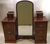 A Victorian mahogany Gentleman's dressing chest with central full length mirror between six deep