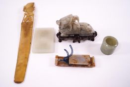 A Chinese jade carving of recumbent beast, 8cm long, with wooden stand,