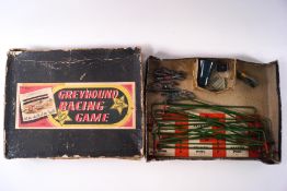A Detoy Greyhound Racing game, comprising five lead greyhound figures, track barriers, stakes card,