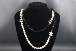 A single strand cultured freshwater pearl necklace with enamel CC interspaced and black glass.