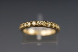 A yellow metal half hoop diamond ring. stated weight of 0.71ct. Hallmarked 9ct gold, Sheffield.