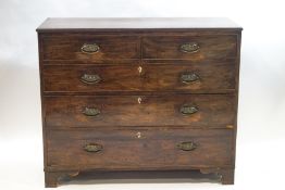 A George III mahogany chest of two short over three long drawers, brass oval ring handles,