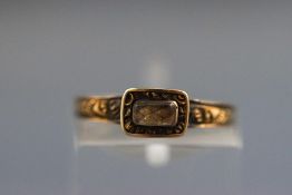 A small Victorian mourning ring with plaited hair section and personal inscription to inner shank.