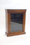 A Victorian rosewood pier cabinet with stringing, the glazed door enclosing two shelves,