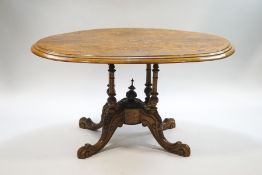 A Victorian walnut tilt top oval table, quarter veneered top, with classical scroll inlay,