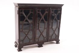 A doll's house mahogany glazed bookcase with eight removable shelves, 16.5cm high x 18.5cm wide x 5.