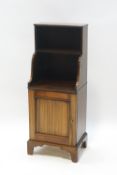 A pair of mahogany cupboards with shelves above, on bracket feet,