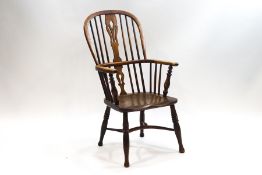 A 19th century elm and ash Windsor chair with shaped and pierced splat to the hooped spindle back