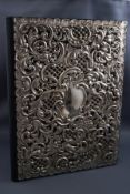 A leather stationery folder with pierced and embossed silver cover in the form of c scrolls and